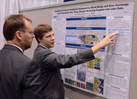 VIMS graduate student Jon Loftis discusses his work on storm-surge modeling during a scientific meeting.