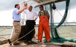 VIMS Professor Rob Latour describes the importance of fish-monitoring programs to Governor Terry McAuliffe aboard the Bay Eagle as first mate Keith Mayer looks on. © Michaele White/VA Governor's Office.