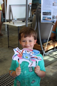 Myles Belote, Jr., 4, holds up his drawing of a blue crab at VIMS' Marine Life Day. C. Katella/VIMS