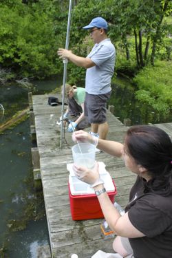 Song joins with graduate student Ann Arfken (L) and marine scientist Marta Sanderson (R) to collect  samples from an over-fertilized lake for nitrogen analysis.