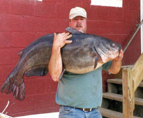 An angler holds a large blue catfish. Photo courtesy of Greg Garmin/VCU.