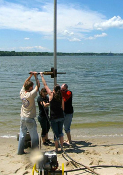 These researchers aren't tipping the goal posts after a big win. Instead, they are using a vibracorer to study groundwater entering the York River from beneath the VIMS beach. Photo by Mary Goodwyn.