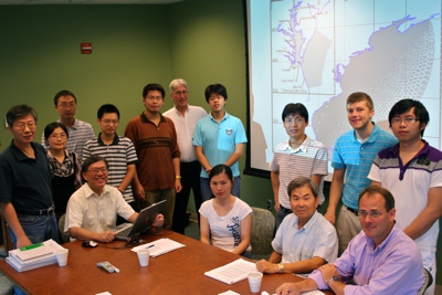 VIMS professor Harry Wang (at laptop) and his Estuarine and Coastal Modeling Group won a 2011 Governor's Technology Award from the Commonwealth of Virginia. Sitting from L:  Wang, postdoctoral researcher Bo Hong, emeritus professor Albert Kuo, and research assistant professor David Forrest. Standing (from L): professor Jian Shen, visiting scientists Yanqiu Meng and Fei Ye, graduate students Zhengui Wang and Xiaoteng Shen, marine scientist Mac Sisson, graduate student Yi-cheng Teng, visiting scientist Hongzhou Xu, and graduate students Jon Loftis and Qubin Qin.