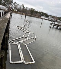 a series of paired taylor floats of to the right of a pier in Sarah's Creek