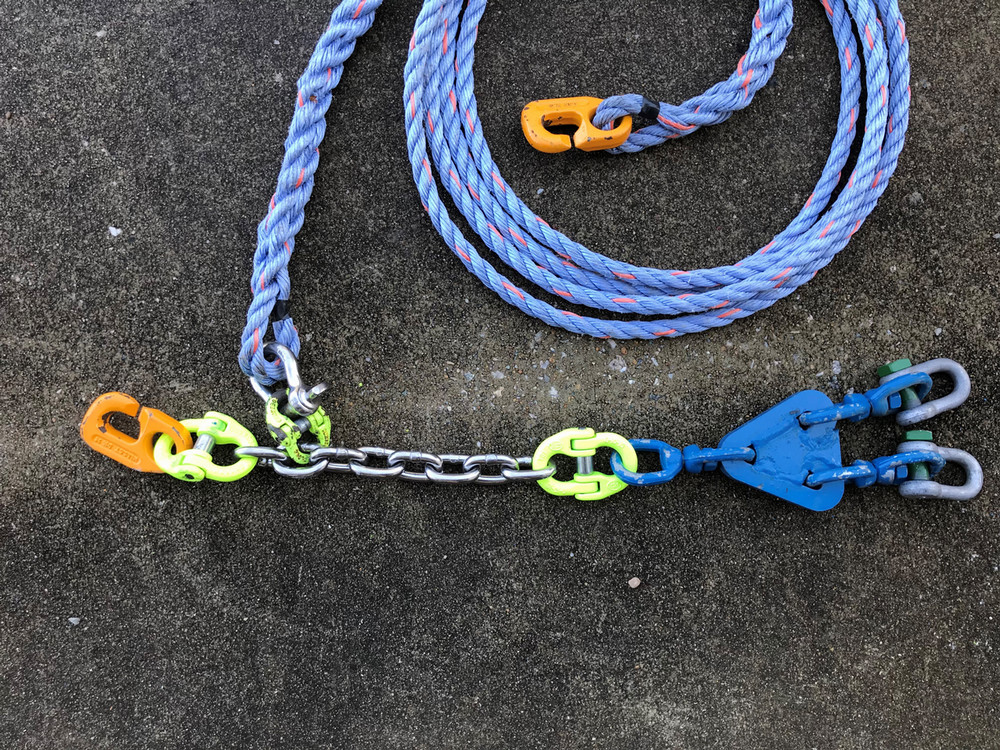 coiled rope attached to chain with links attached to swivel plate