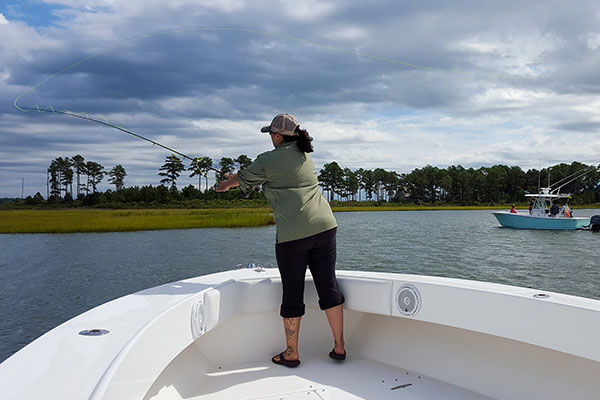 An angler casts her fly line near a marsh in Virginia’s Middle Peninsula. 